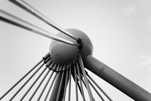 Free Black and white abstract view of a modern bridge's cable structure against the sky. Stock Photo