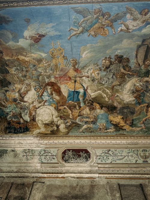 Free Baroque ceiling fresco depicting a historical battle scene in a Palermo palace. Stock Photo
