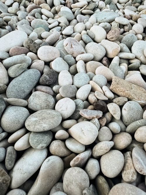 Free Close-up view of smooth pebbles on a Montenegro beach, showcasing natural texture. Stock Photo