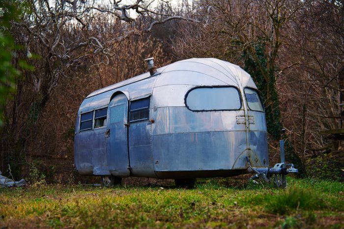 Vintage silver caravan in a forest