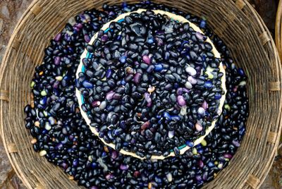 Dried black beans in a woven basket. Photo by christian hembert on Pexels.