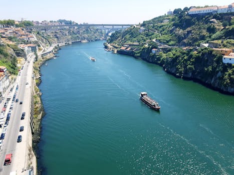 A stunning aerial view of the Douro River with the Arrábida Bridge in Porto, Portugal.