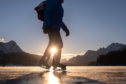 Silhouette of an ice skater at sunrise, Sils im Engadin, Swiss Alps.