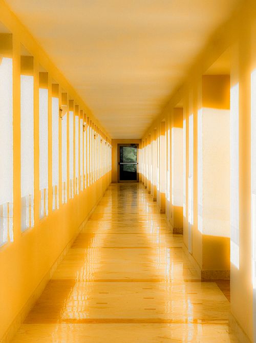 Free Bright yellow hallway with sunlit reflections and modern design. Stock Photo