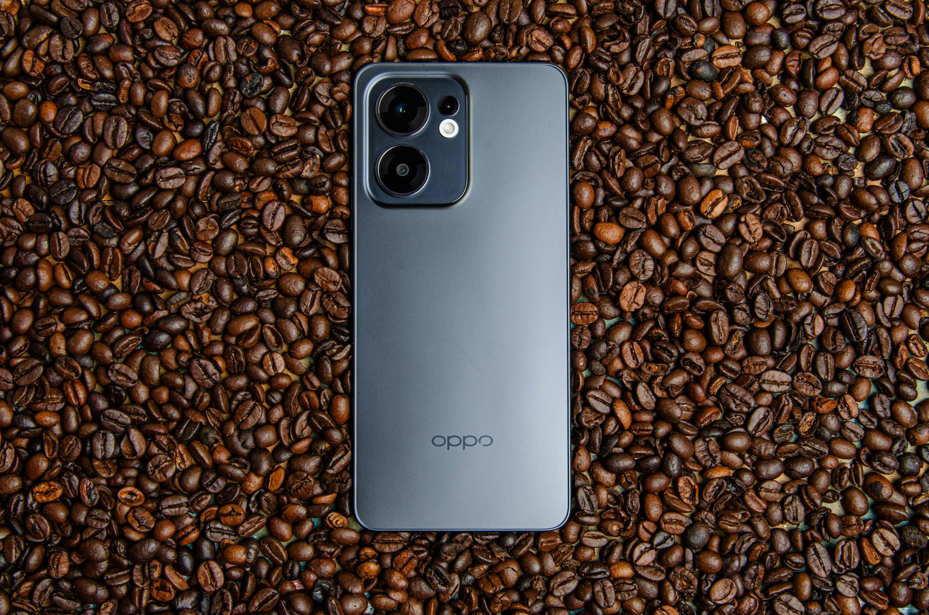 A sleek smartphone rests elegantly on a bed of coffee beans, showcasing modern design and technology.
