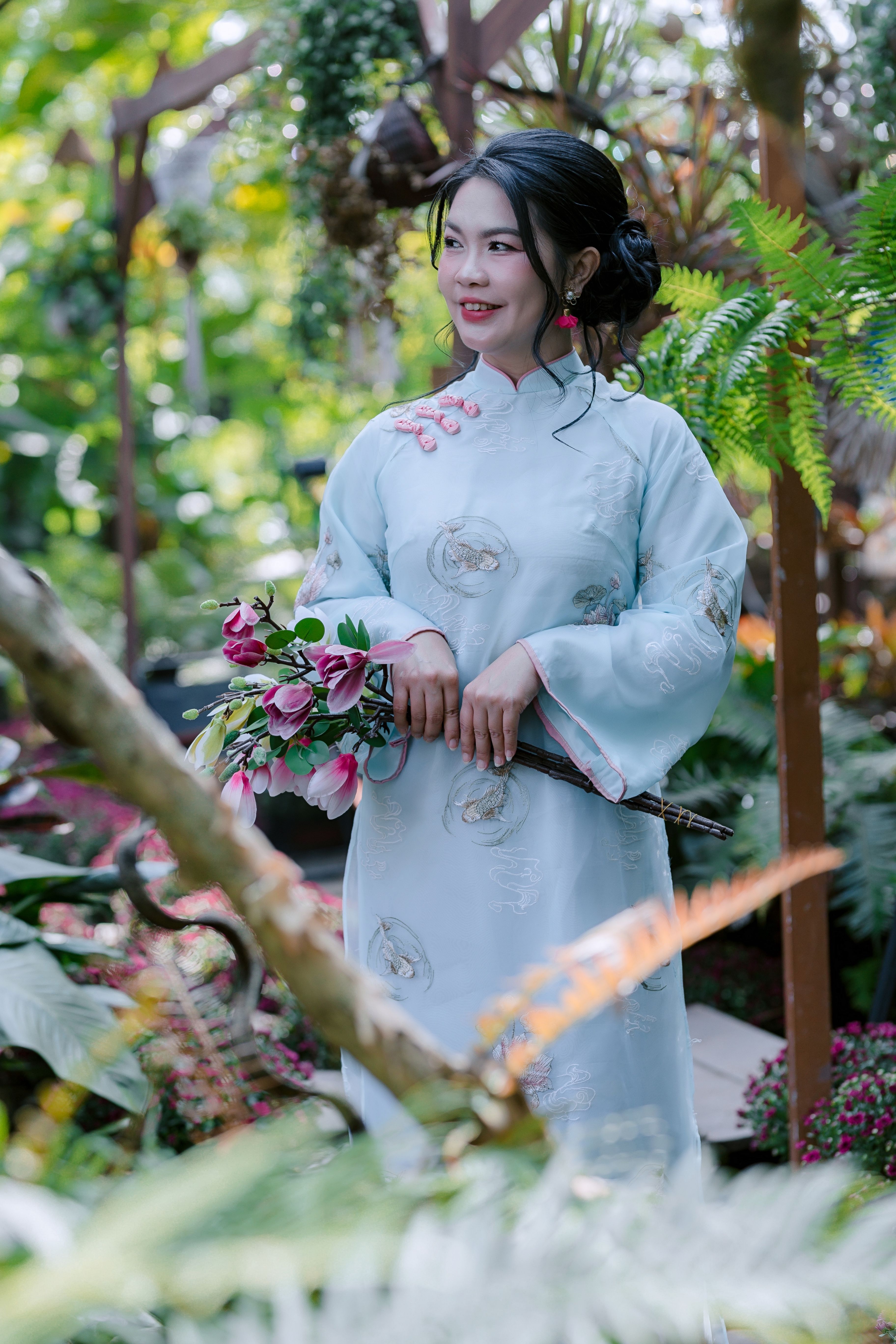 Woman in Traditional Dress Holding Flowers Outdoors · Free Stock Photo