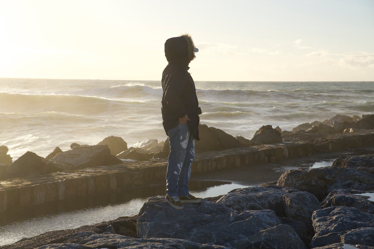 Person writing in journal reflecting on recovery journey and lessons learned