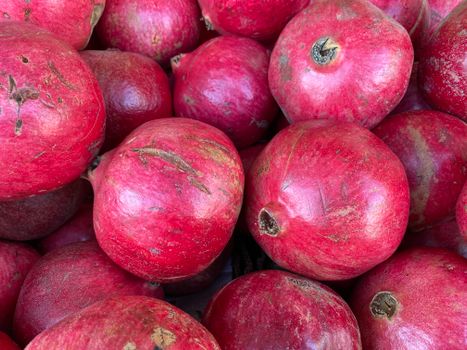 Close-up of ripe pomegranates with rich red hues, perfect for healthy eating concepts.