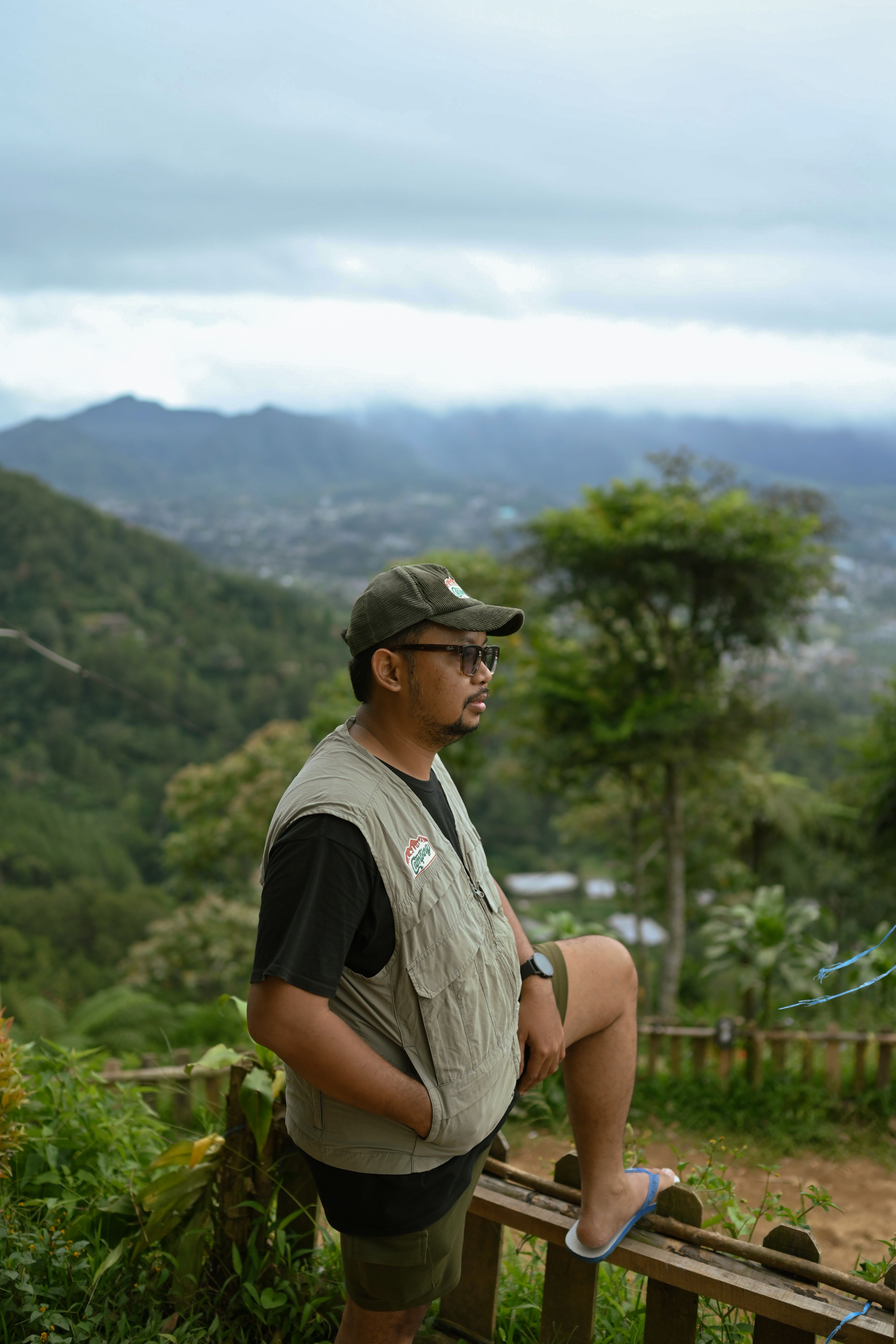 Man enjoying scenic mountain view in Indonesia, perfect for outdoor enthusiasts.