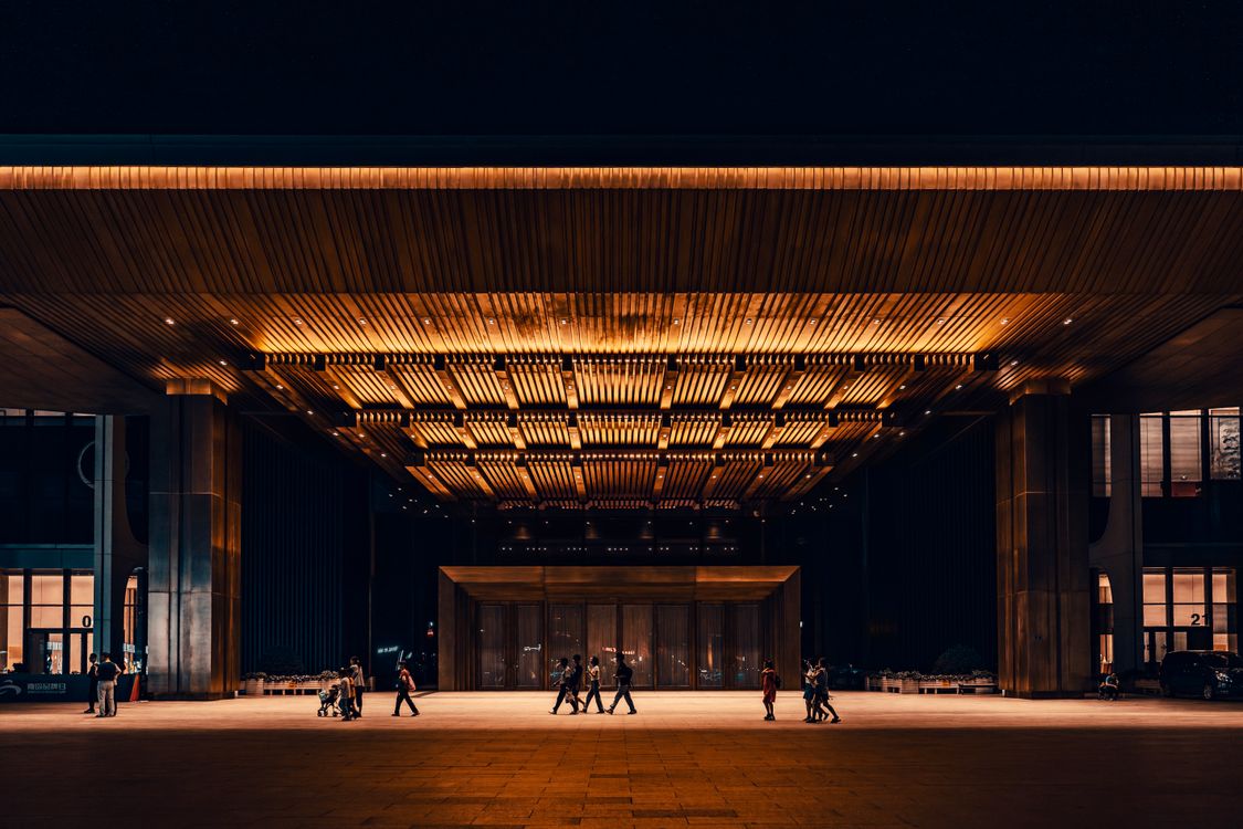 Modern Building Entrance at Night with Warm Lighting · Free Stock Photo