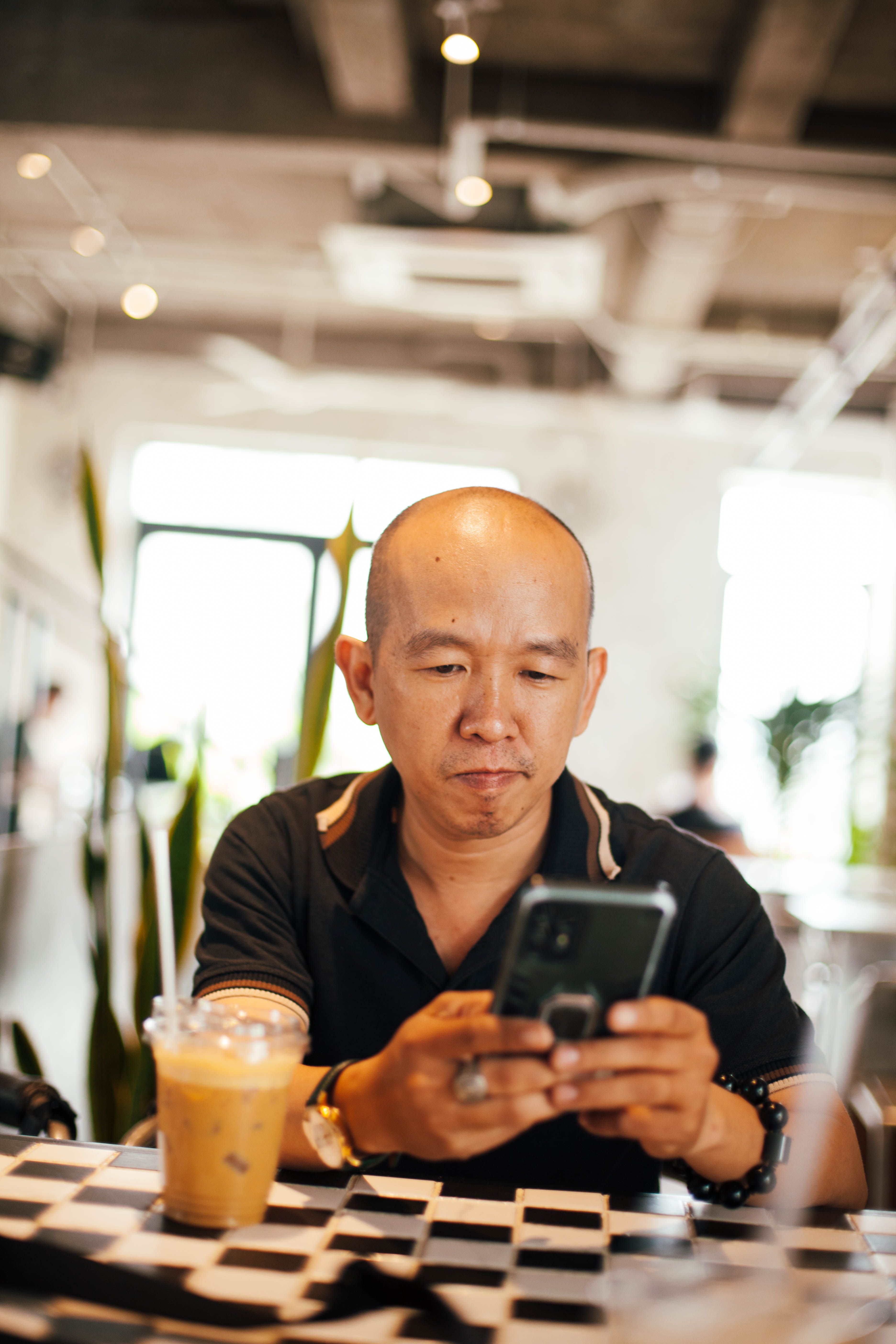 Man using a phone in a café