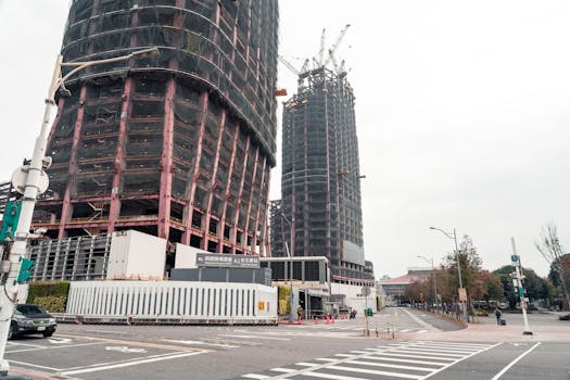Skyscrapers under construction in Taipei, Taiwan with urban infrastructure and cranes visible