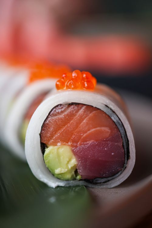 Free Vibrant close-up of a sushi roll featuring fresh salmon, tuna, avocado, and caviar, showcasing culinary artistry. Stock Photo
