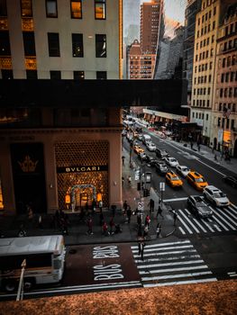 Capture the dynamic essence of New York City's streets with bustling traffic and iconic buildings at dusk.