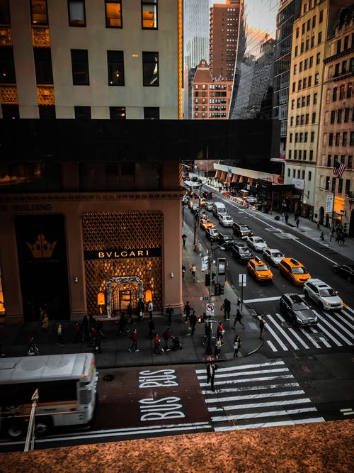 Free Capture the dynamic essence of New York City's streets with bustling traffic and iconic buildings at dusk. Stock Photo