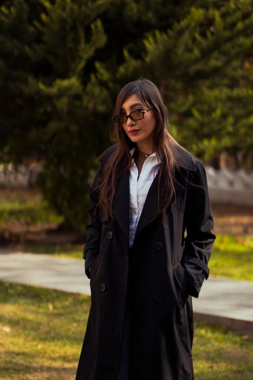 Free Fashionable woman with long hair and glasses in a park in Tehran, Iran. Stock Photo