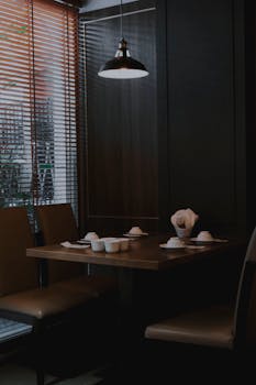 Intimate and elegant dining area in a Taipei restaurant with modern decor and ambient lighting.