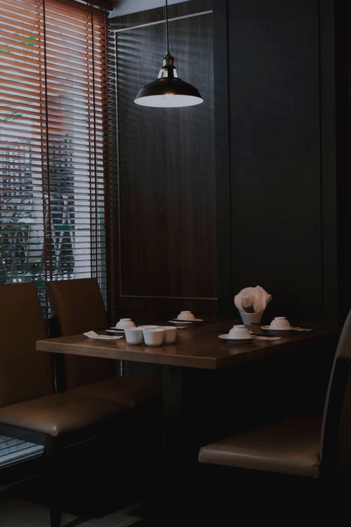 Free Intimate and elegant dining area in a Taipei restaurant with modern decor and ambient lighting. Stock Photo