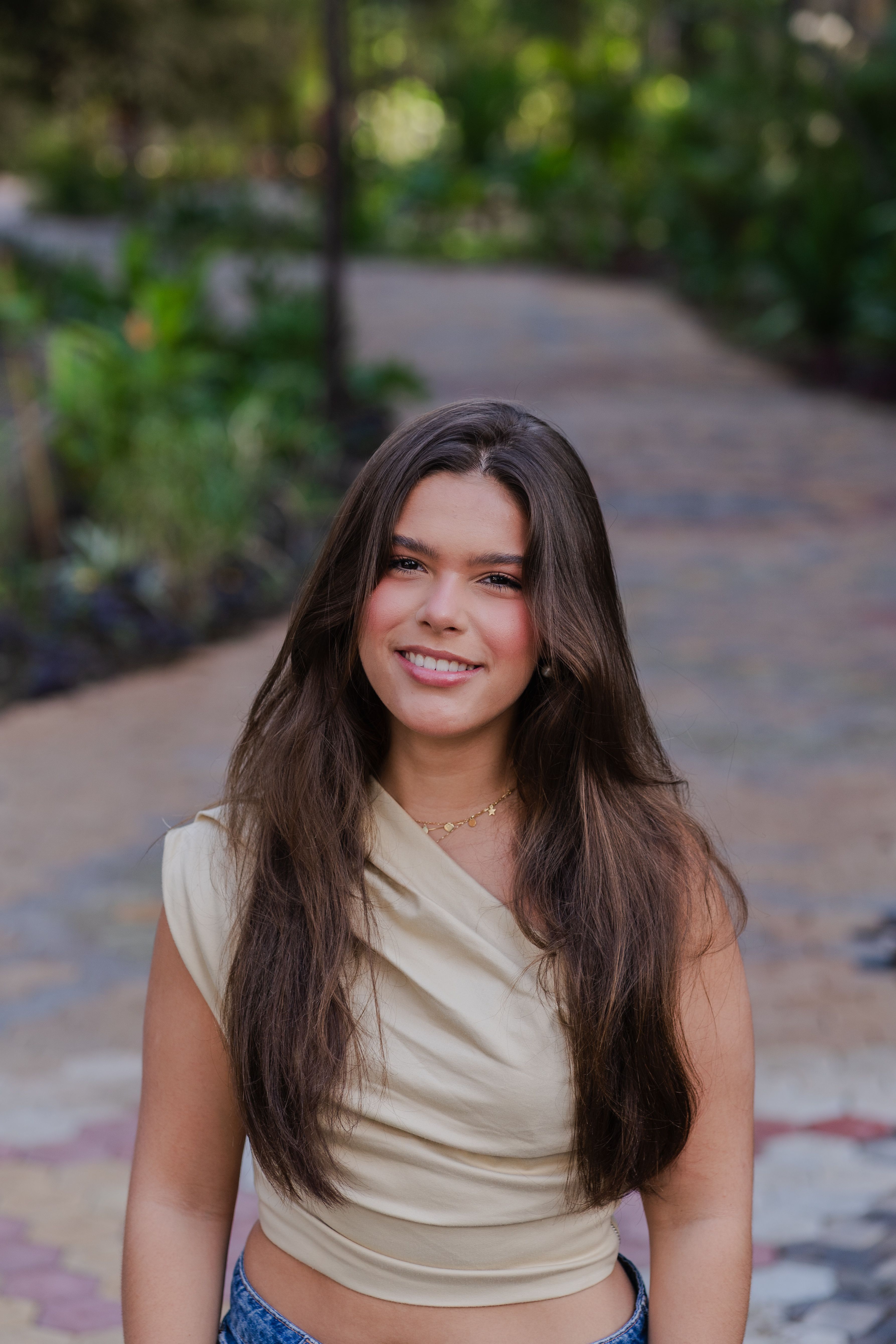 Smiling Young Woman Outdoors in Natural Setting · Free Stock Photo