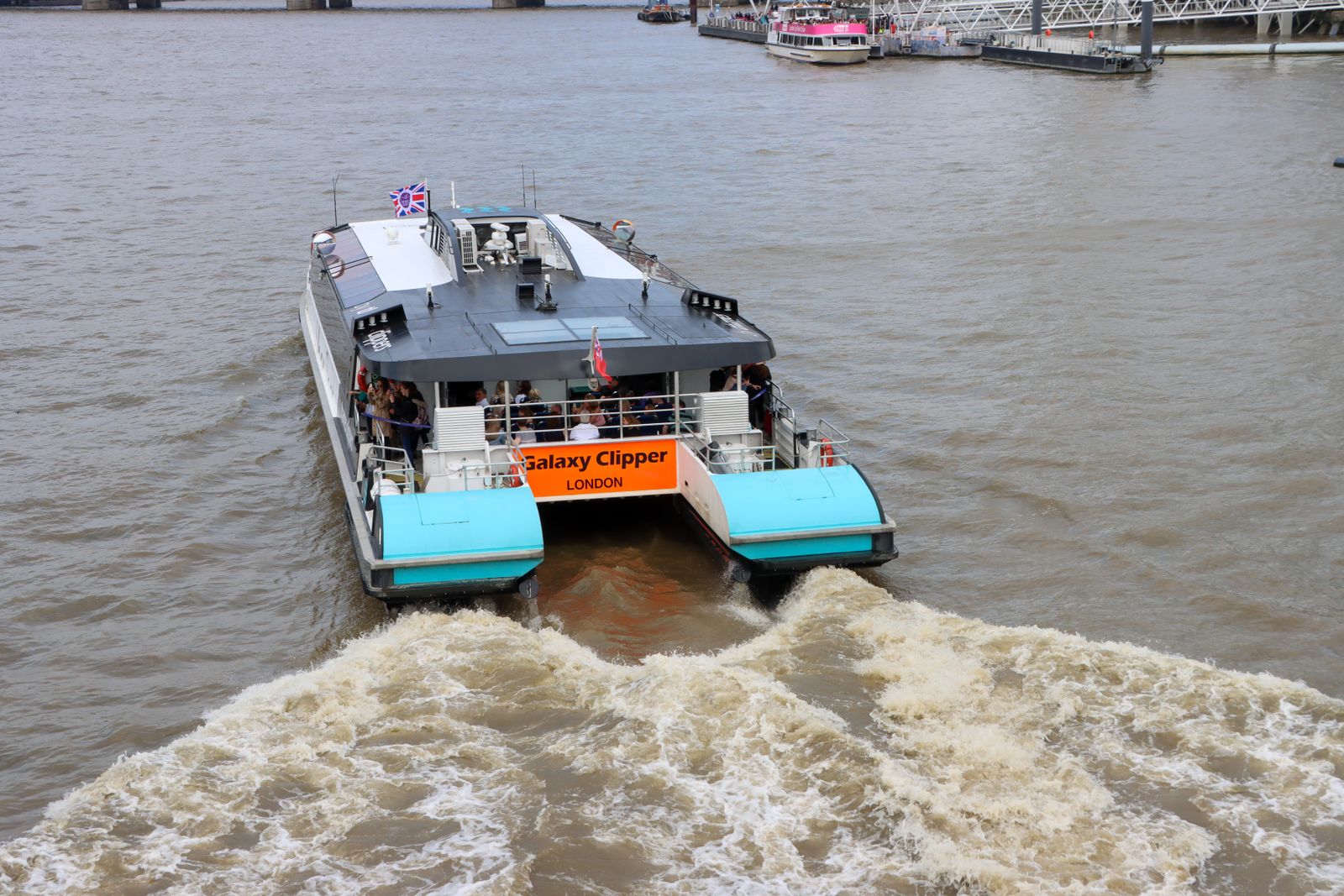 A Thames Clipper river bus catamaran cruising the River Thames in London
