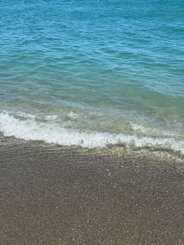 Serene beach shoreline with gentle waves lapping the sand, perfect for relaxing scenes.