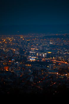 Stunning panoramic night view of Tbilisi's illuminated skyline showcasing the vibrant city lights.