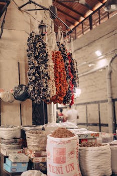 Vibrant dried vegetables hang in a traditional spice market, showcasing rich flavors and textures.