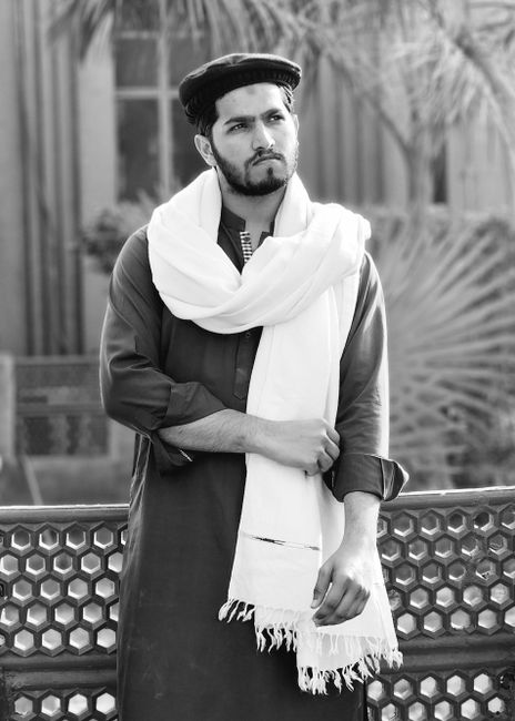 Portrait of a Pakistani man in traditional attire with a shawl outdoors. - Expert Tips for Choosing the Right Handbag for Any Occasion