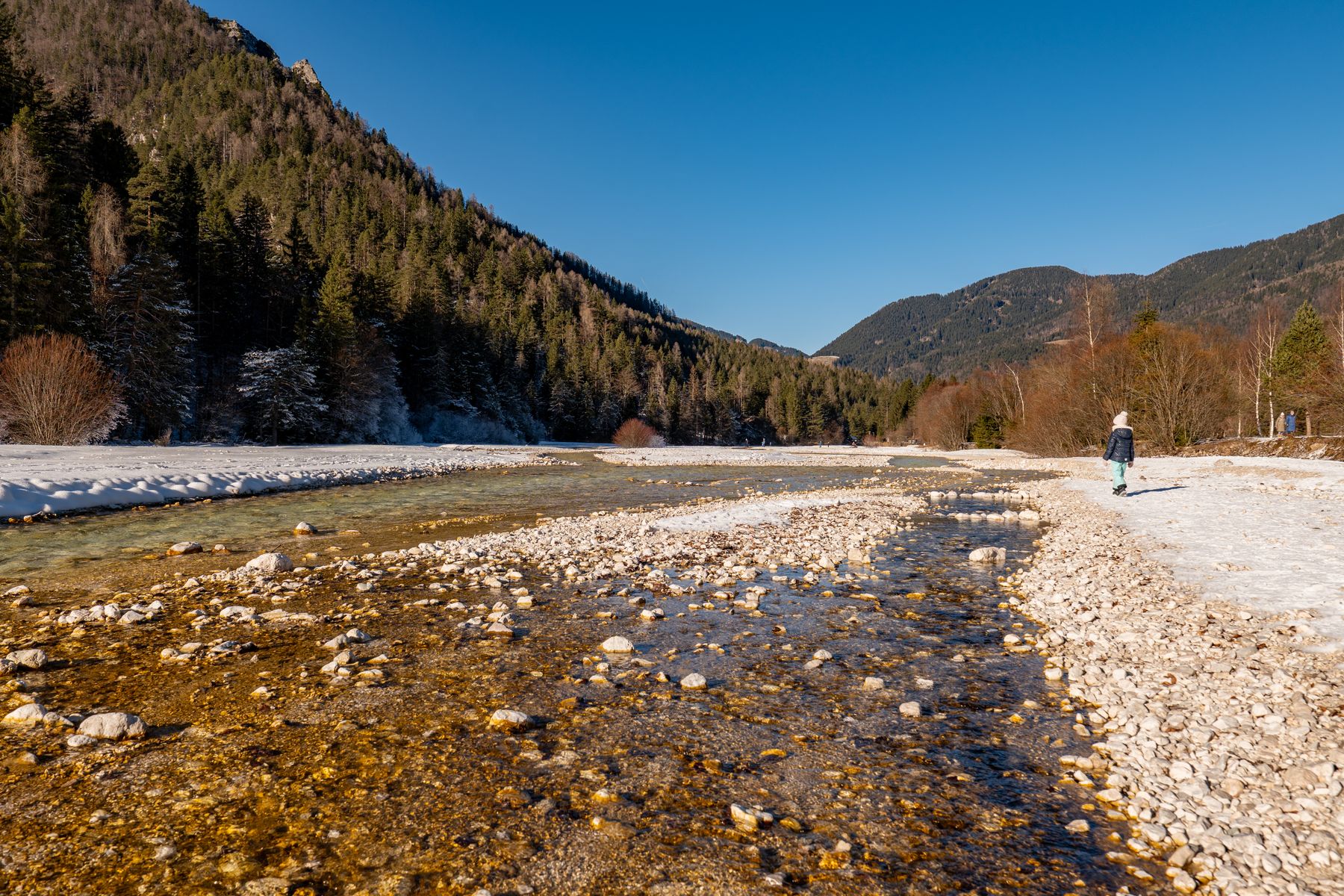 Winter landscape in Kranjska Gora with mountains and a river