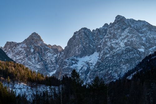 Free Majestic snow-covered peaks of Kranjska Gora under a clear blue sky. Stock Photo