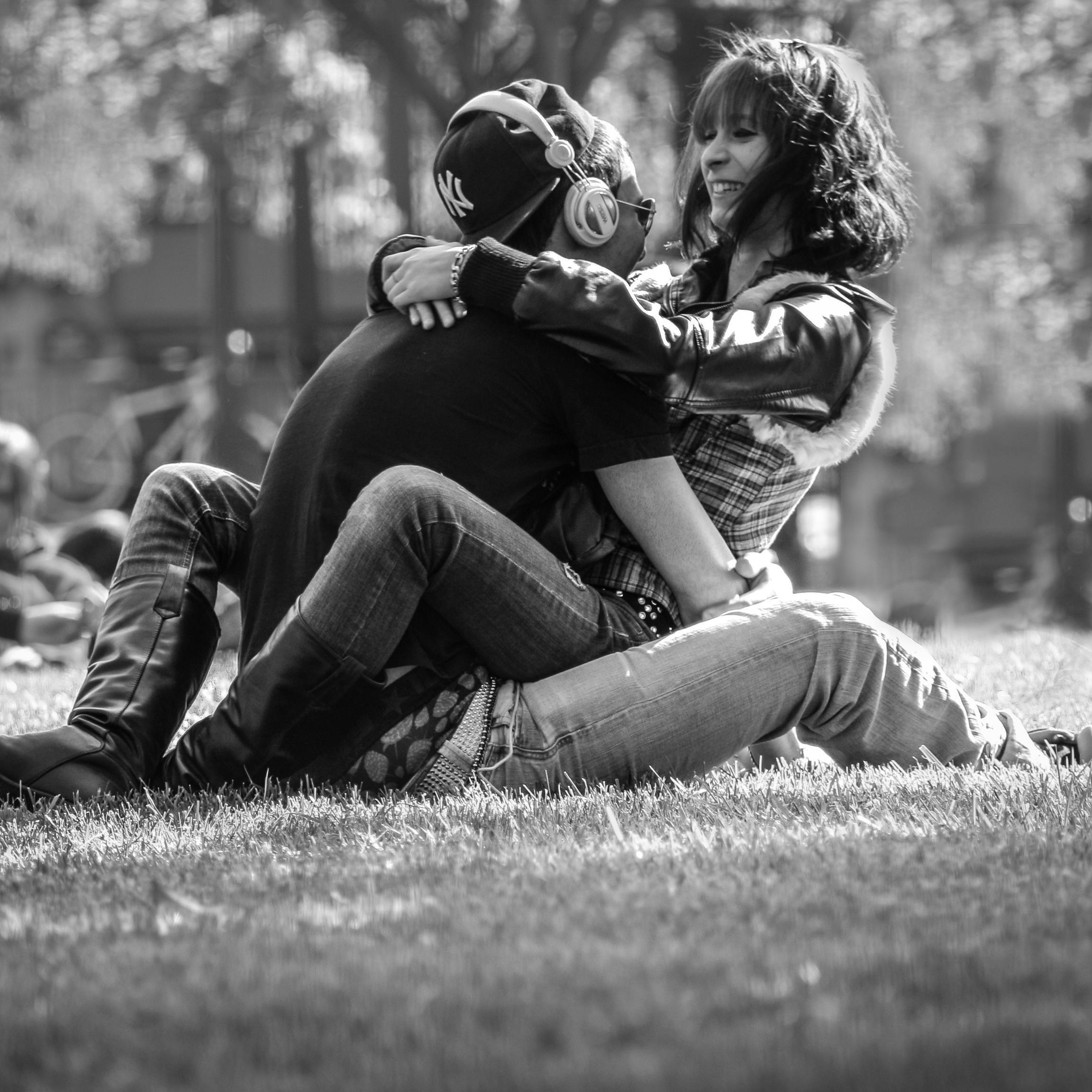 Grayscale Photo Of Man And Woman Hugging On Grass Free Stock Photo