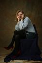 Selective Focus Photography of Woman Sitting on Chair While Holding Her Face