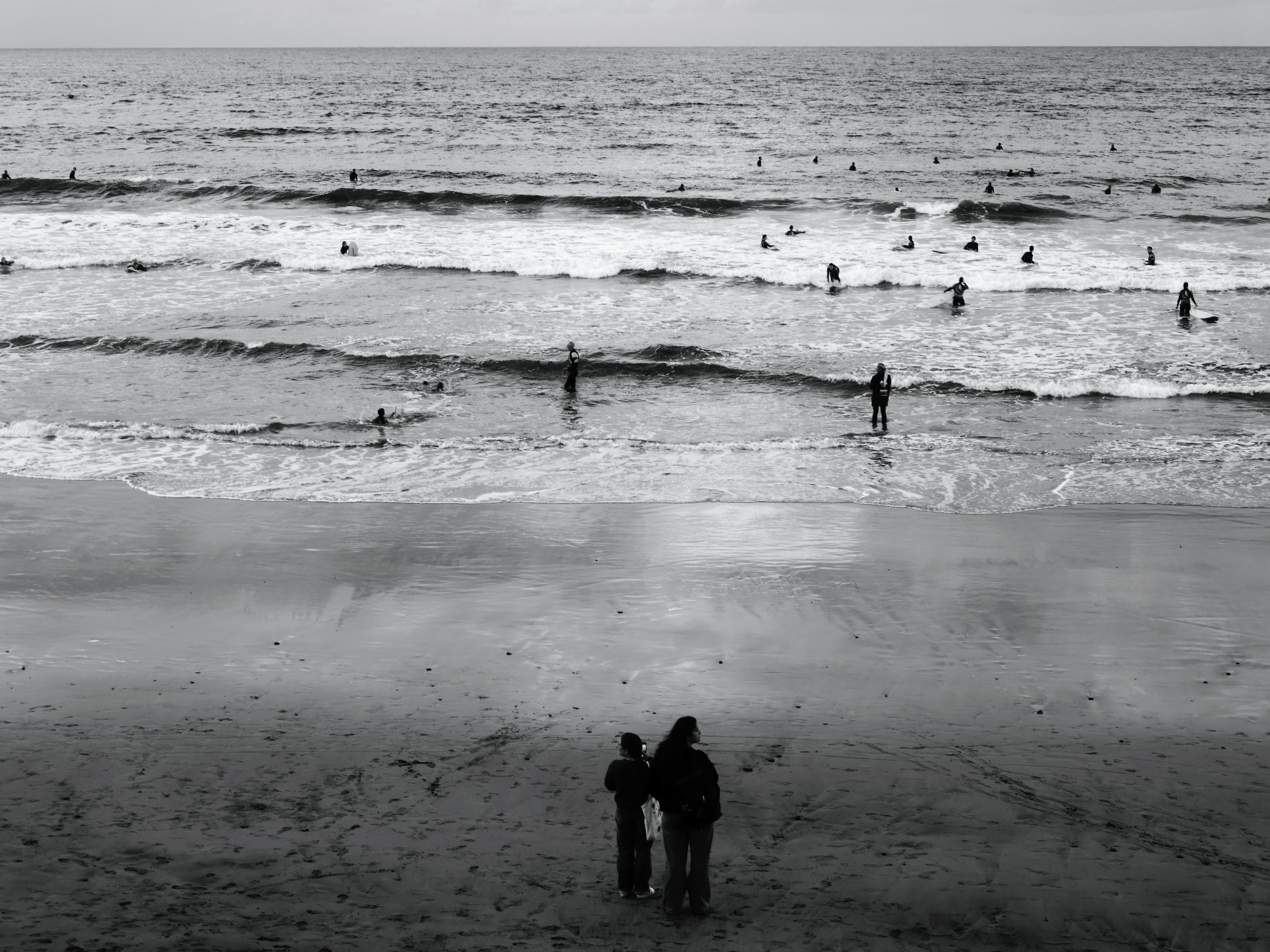 Black and White Beach Scene with Surfers · Free Stock Photo