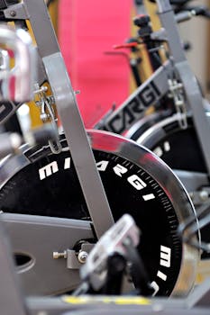Detailed view of stationary exercise bikes in a fitness gym setting.