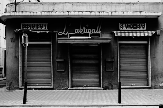 Moody black and white photo of a closed restaurant in Barcelona.