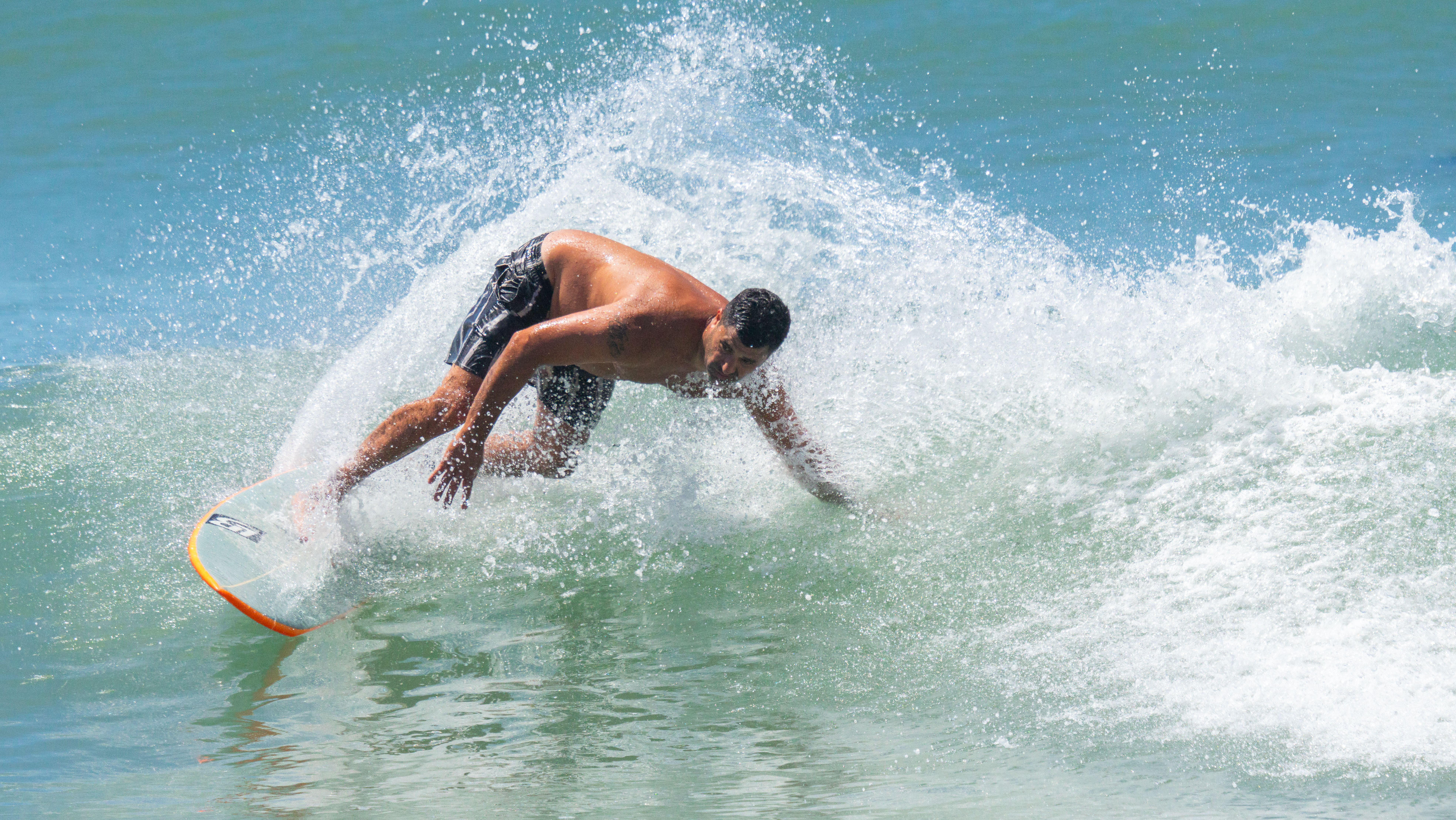 Surfer riding waves at Bali's stunning coastline