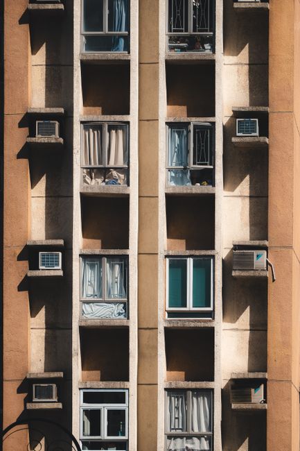 A detailed view of a geometric apartment facade in Hong Kong showcasing urban architecture.