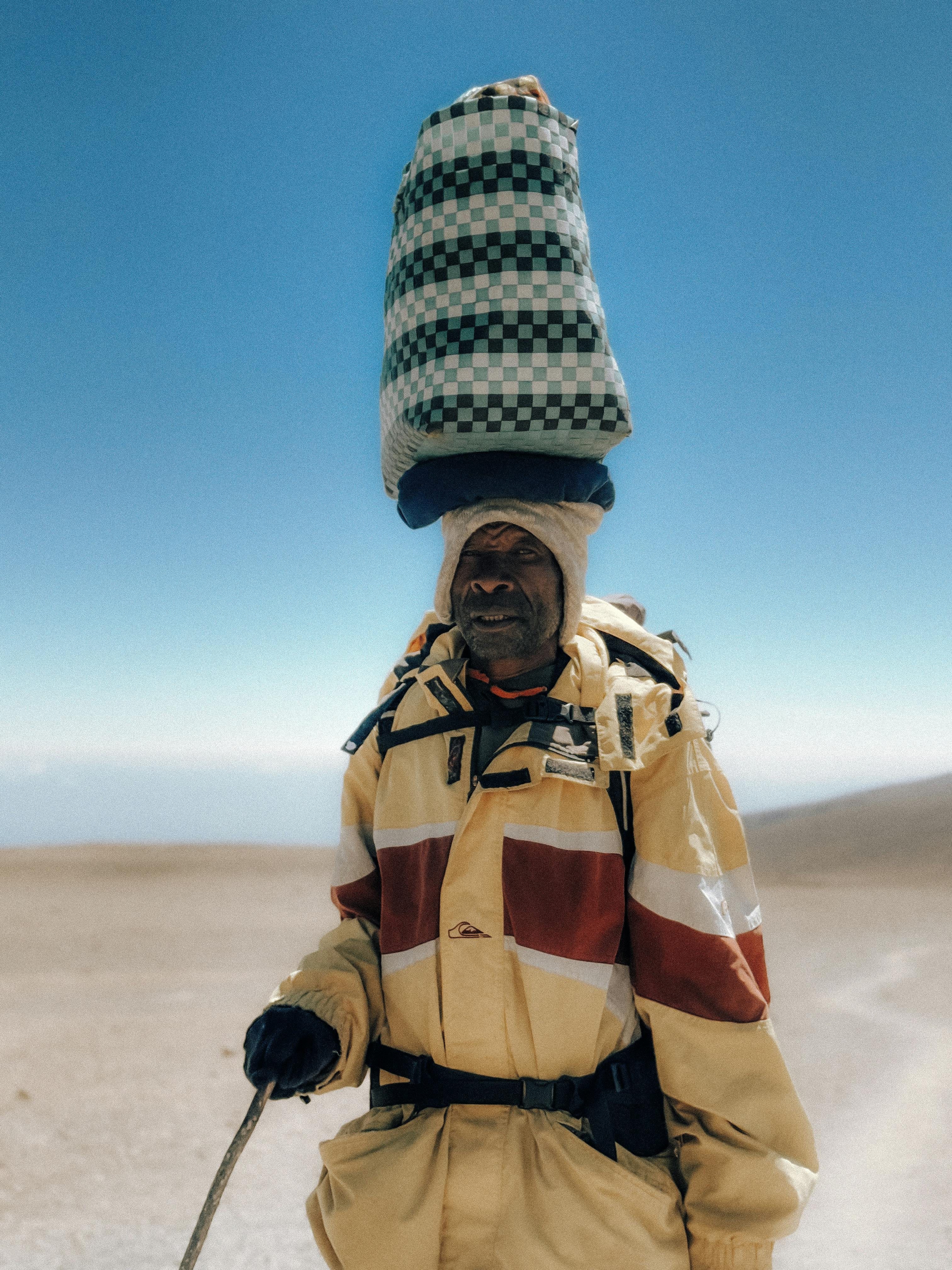 A porter with supplies on Mount Kilimanjaro, Tanzania, showcasing local culture and endurance.