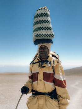 A porter with supplies on Mount Kilimanjaro, Tanzania, showcasing local culture and endurance.