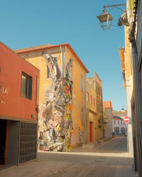 Vivid mural on a building in Porto, showcasing modern street art against a traditional backdrop.