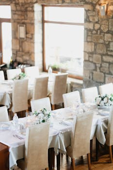 Beautifully decorated wedding reception table with floral centerpieces in a cozy, rustic venue.