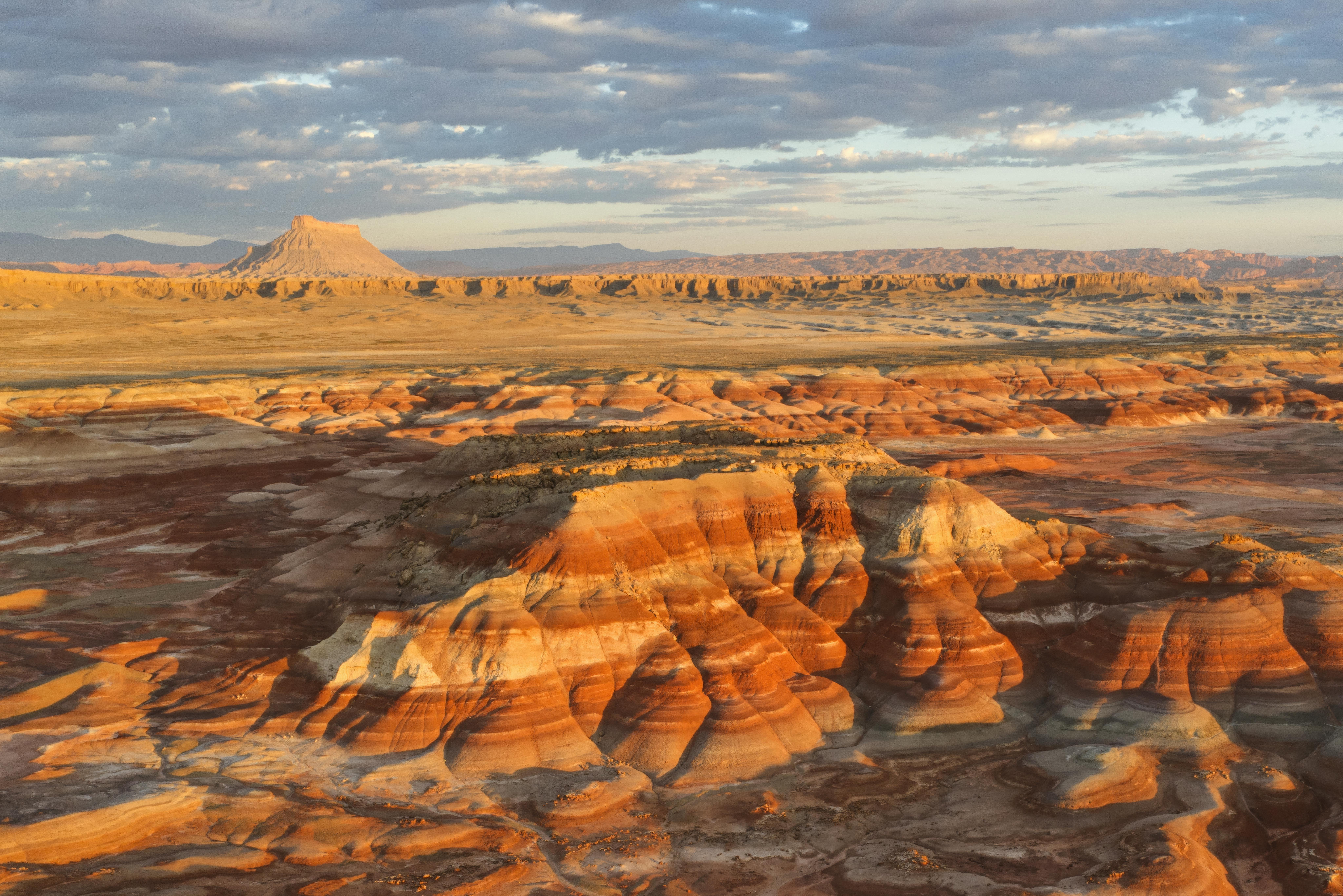 A breathtaking aerial view of Utah's desert badlands showcasing colorful layered rock formations.