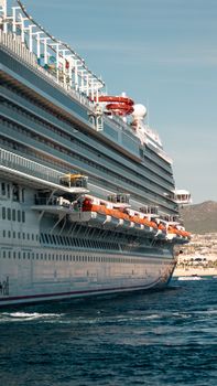 A luxury cruise ship at the port of Cabo San Lucas, Mexico, showcasing travel elegance.
