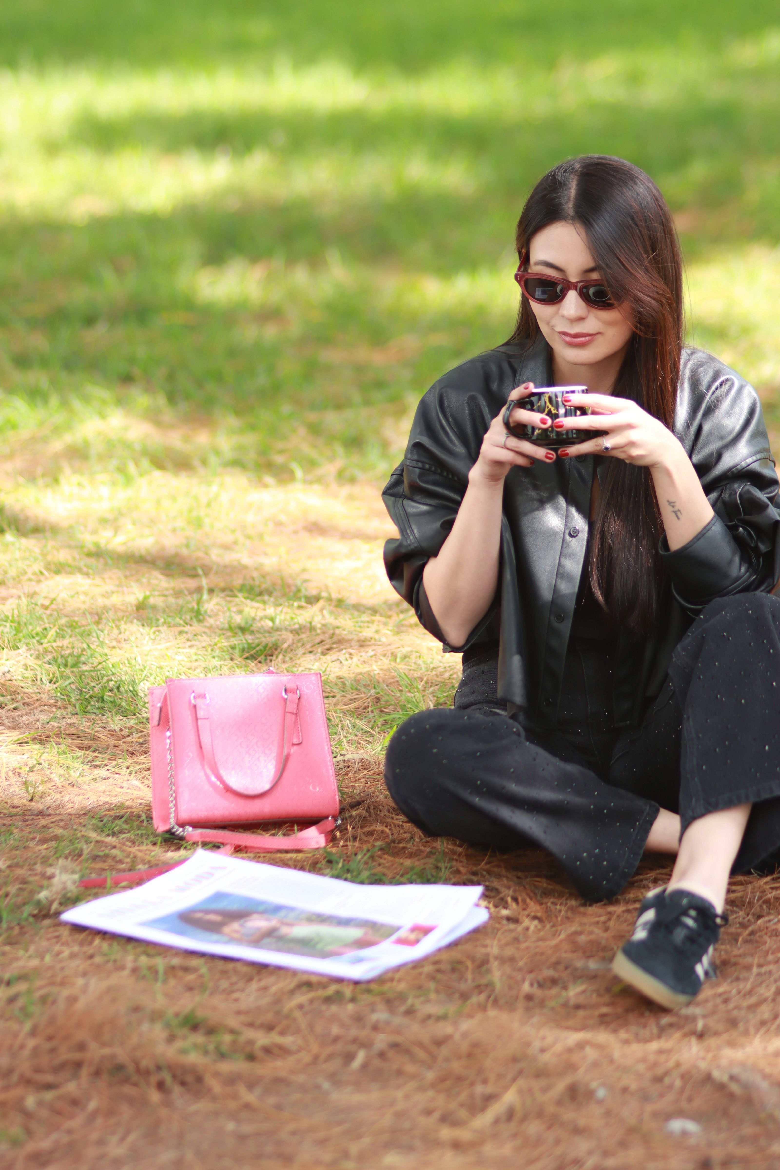 Young Woman Enjoying Coffee Outdoors in Bogotá Park