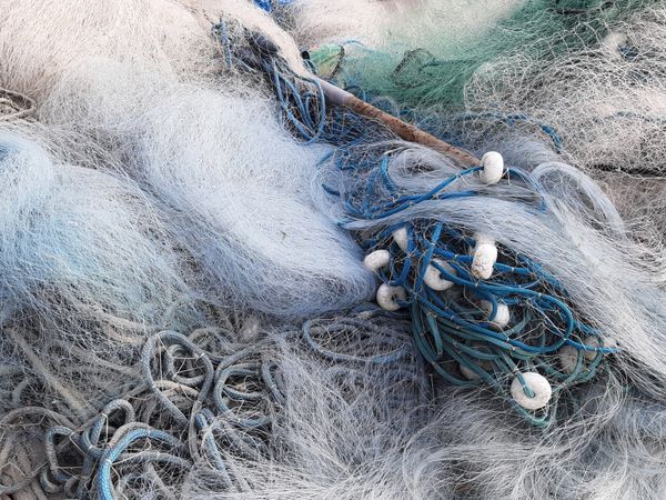 Close view of knotted fishing net and rope — photo by Maria Lucia Sampaio on Pexels