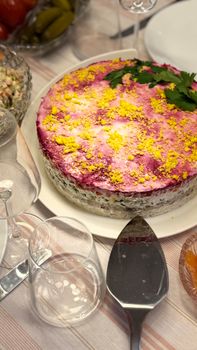 Colorful Russian layered salad topped with beets and eggs, perfect for celebrations.