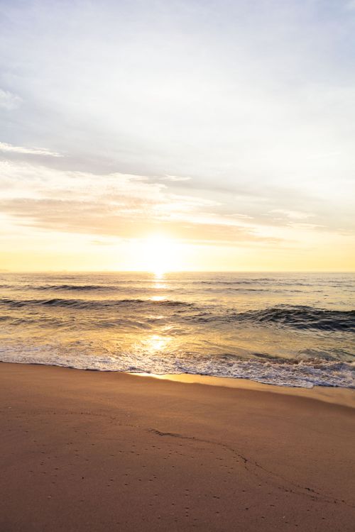 Golden Sunrise Over Tranquil Beach Waves · Free Stock Photo