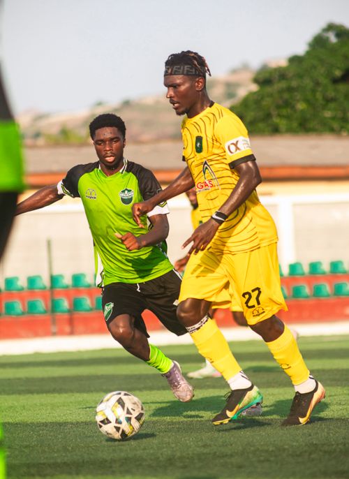Free Two soccer players in action during a competitive match on a sunny day. Stock Photo