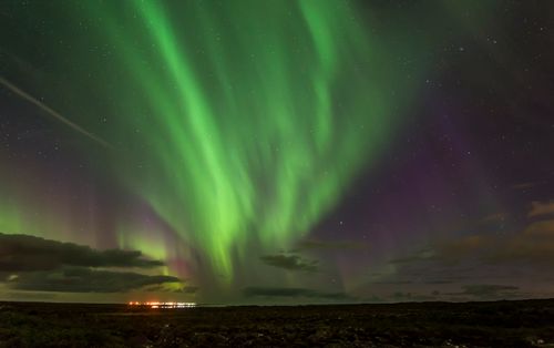 Free Magnificent northern lights display with vibrant green hues over the Icelandic night sky. Stock Photo