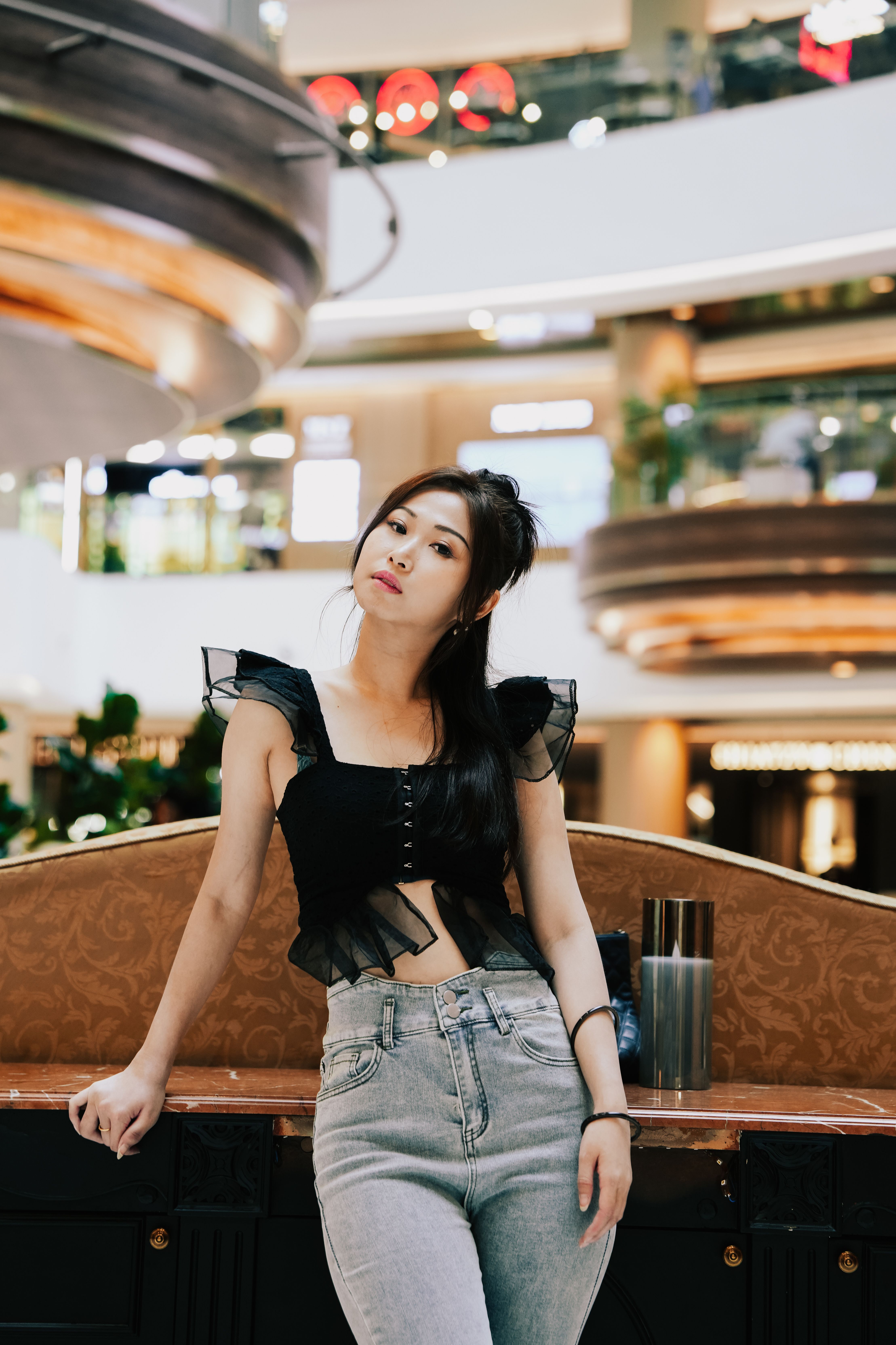 Stylish Woman Posing in Modern Shopping Mall